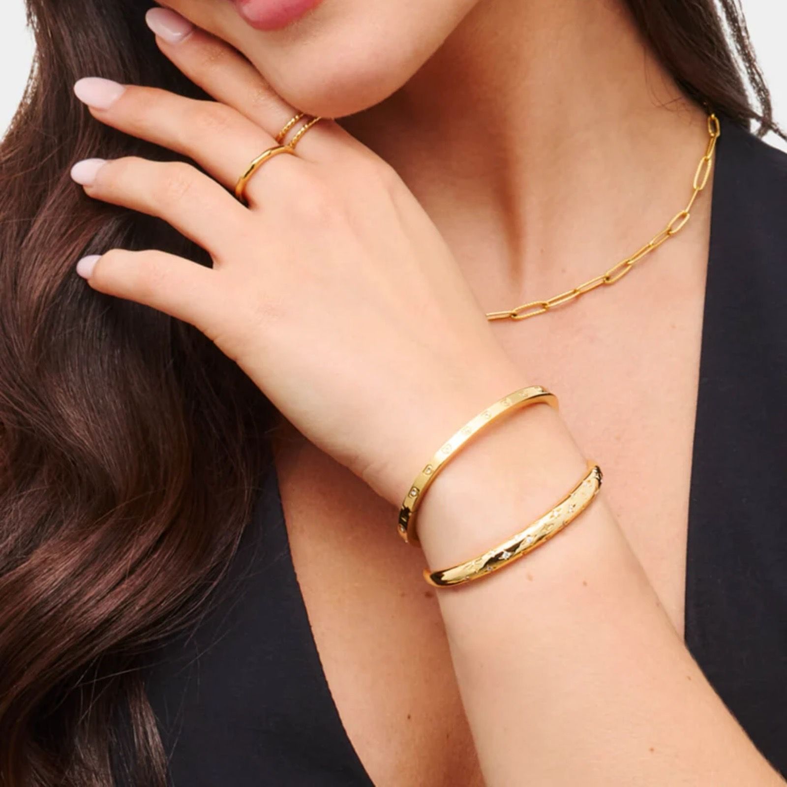 Gold cuff bangles, paperclip chain and stacking rings crafted by DVNJEWELRY